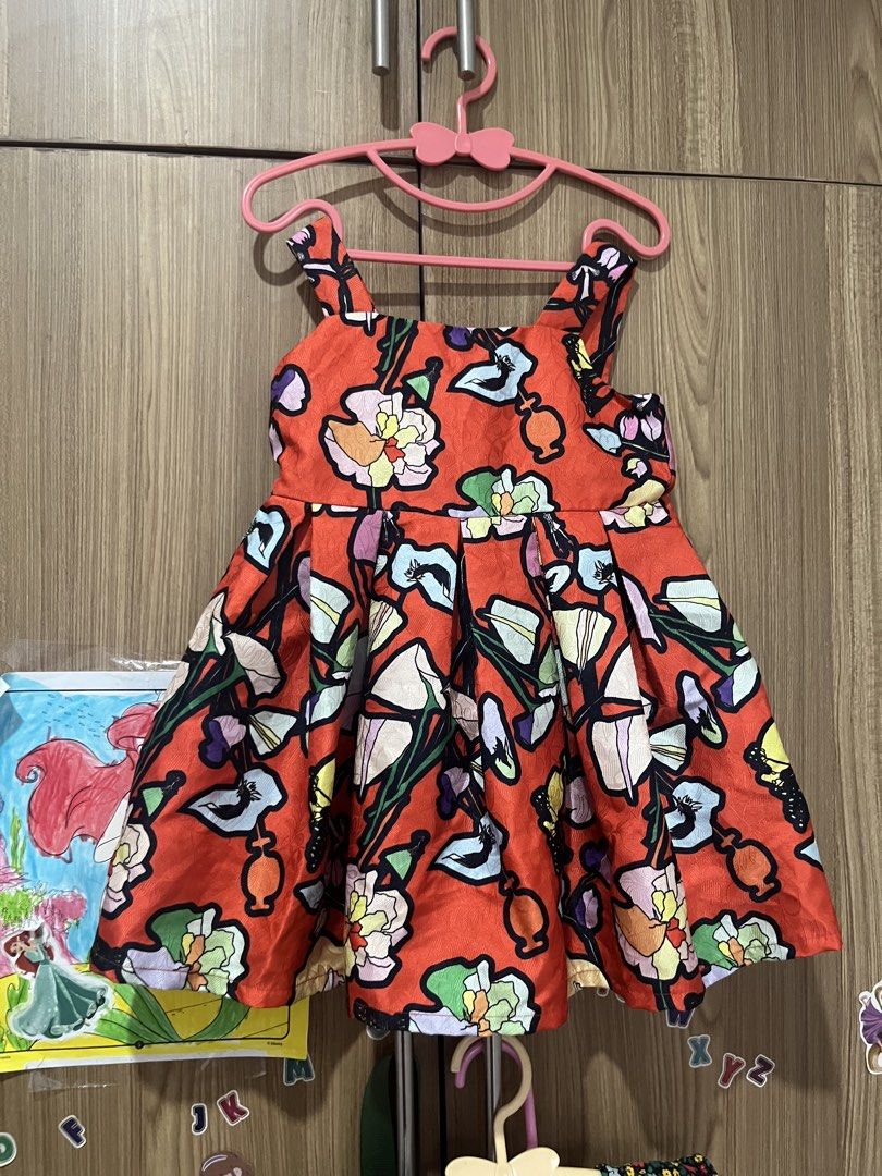 Mini Peace Floral Dress Size 110 (Category: Babies & Kids Fashion) located in Pasig City. Submitted by stormyera19 (Listing ID 1463020908, Image 2). Description: - Adorable red dress with a vibrant floral print. - Features a flattering flared skirt. - Comfortable shoulder straps. - Fabric has a lovely sheen. - Ideal for parties, casual outings, or everyday wear. - Nice and vibrant print perfect for Christmas! - Size 110 / fits 2-3 years old - Hon