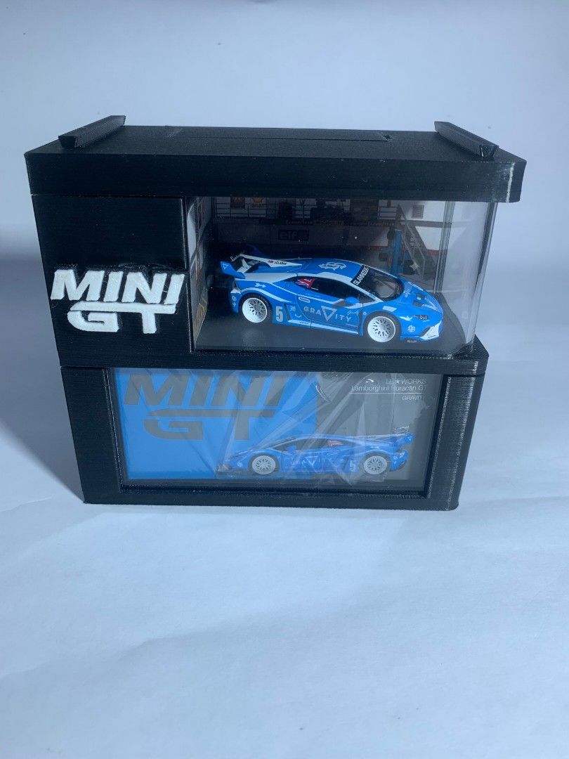 MINIGT DISPLAY CASE (Category: Designer & Blind Box Toys) located in Rizal. Submitted by project.streetwear (Listing ID 1463049640, Image 1). Description: What’s Inside the Box / Package Inclusions: 📦 1x Main Display Case (Diorama Garage Design with Original Box Slot) 🔲 1x Square Acrylic Panel ↪️ 1x Bended Acrylic Panel 🔋 2x AA Batteries (Included for lighting setup) 📌 2x Tack-It / Adhesive Pads (Para steady at di gumagalaw ang diecast.