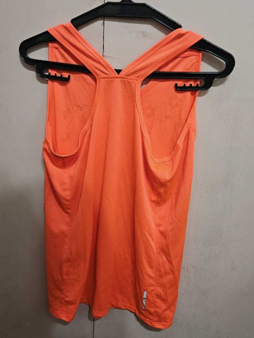 Mizuno Orange Athletic Tank Top (Category: Sleeveless) located in Quezon City. Submitted by jeannego (Listing ID 1462951708, Image 2). Description: - Orange Mizuno athletic tank top - Lightweight and breathable material - Ideal for running, workouts, and sports - Racerback design for enhanced freedom of movement - Features a subtle all-over floral pattern.