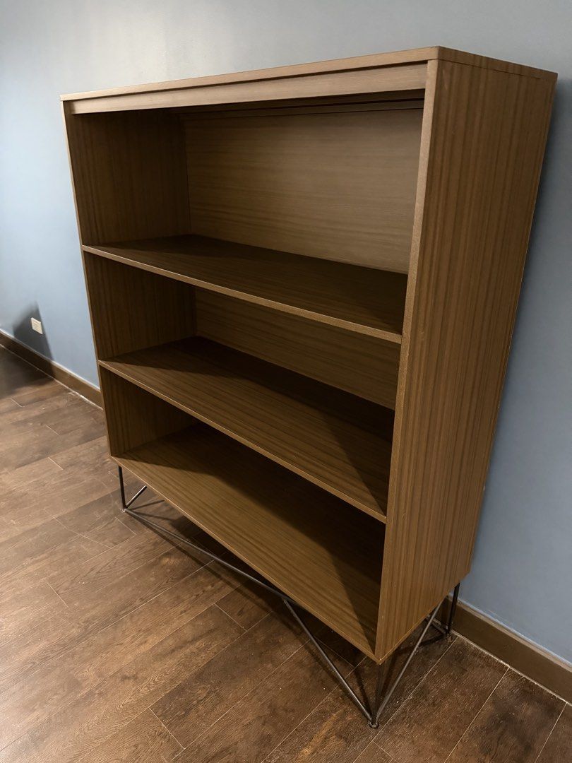 Modern Dark Wood Shelf (Category: Shelves, Cabinets & Racks) located in Quezon City. Submitted by chicfindsmnl (Listing ID 1463033661, Image 2). Description: - Darker in actual Ideal for books, decor, and display items - Fits well in any room - Dimensions: 140cm height 120cm width 40 cm depth .