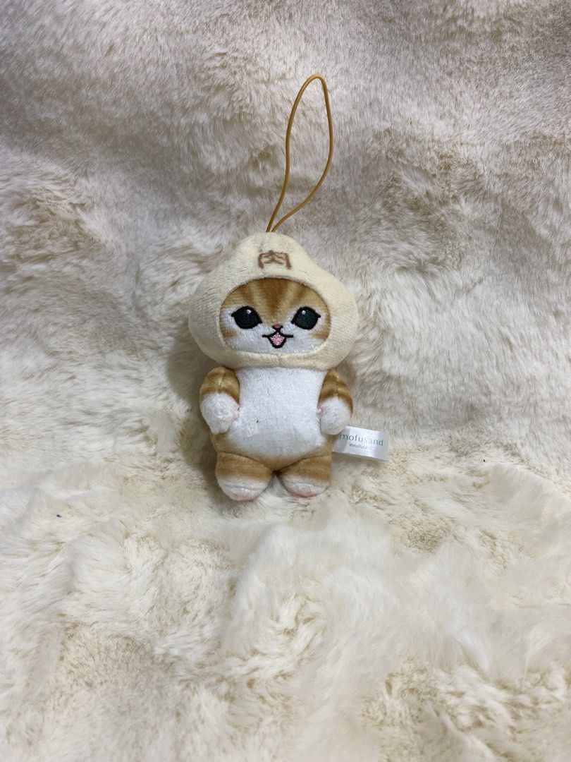 Mofusand Nyanko pork bun plush charm (Category: Plushies & Soft Toys) located in Kalibo. Submitted by ollie_stuffshop (Listing ID 1463116857, Image 1). Description: Before you send your inquiries: ❗️Last Price is already posted ❗️Manage your expectations, WYSIWYG ❗️May need washing ❗️Dropoff is every Wednesday & Sunday - Adorable Mofusand cat plush toy - Features a cute hood - Soft and squishy texture - Includes a convenient hanging loop - Approx
