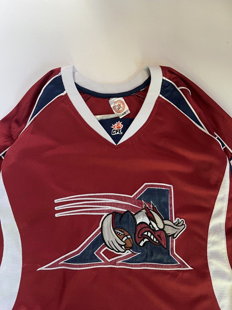 Montreal Alouettes CFL Jersey (Category: Activewear) located in Baler. Submitted by allthrifted31 (Listing ID 1462960558, Image 3). Description: - Montreal Alouettes CFL Jersey - Color: Burgundy with white and navy accents - Features team logo on the front - 'Montreal Alouettes' text on the back collar - Designed for comfort and durability - Perfect for any CFL fan.