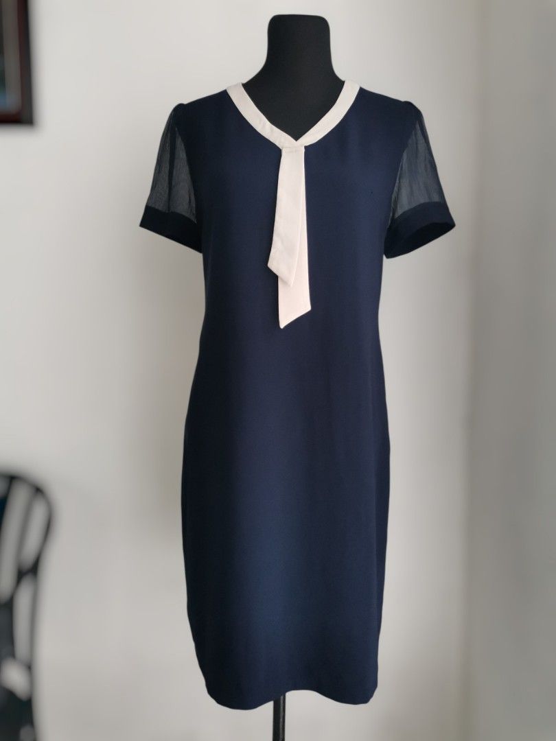 Navy Blue Office Dress (Medium) (Category: Dresses) located in Quezon City. Submitted by engeleaize (Listing ID 1462942587, Image 1). Description: Details: Color: Navy blue with cream color necktie (with faint minimal small dots) Style: Fluid midi dress, tie-neck detail, sheer short sleeves, with size zipper Fabric: Poly-cotton bodice, silk necktie Best worn: Office outfit, semi-formal gatherings Bust: 36 inches Waist: 36 inches Length: 37 inches