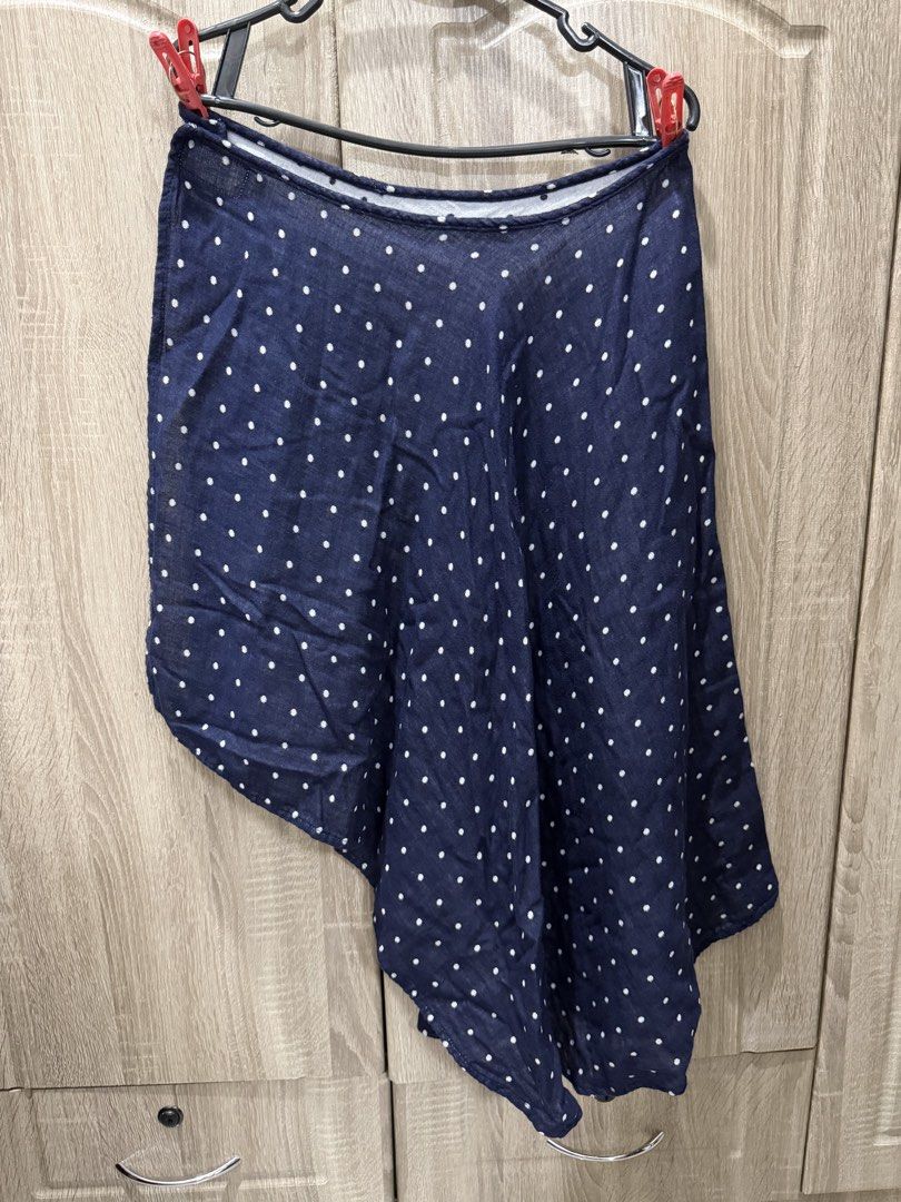 Navy Blue Polka Dot Asymmetrical Wrap Skirt (Category: Skirts) located in Calamba. Submitted by nicalison (Listing ID 1463037302, Image 2). Description: -100% cotton - Cute navy blue skirt with white polka dots - Flowy asymmetrical hemline - Lightweight and comfortable fabric - Small tear near waistband (visible in last photo) - Wearable with minor mending needed.