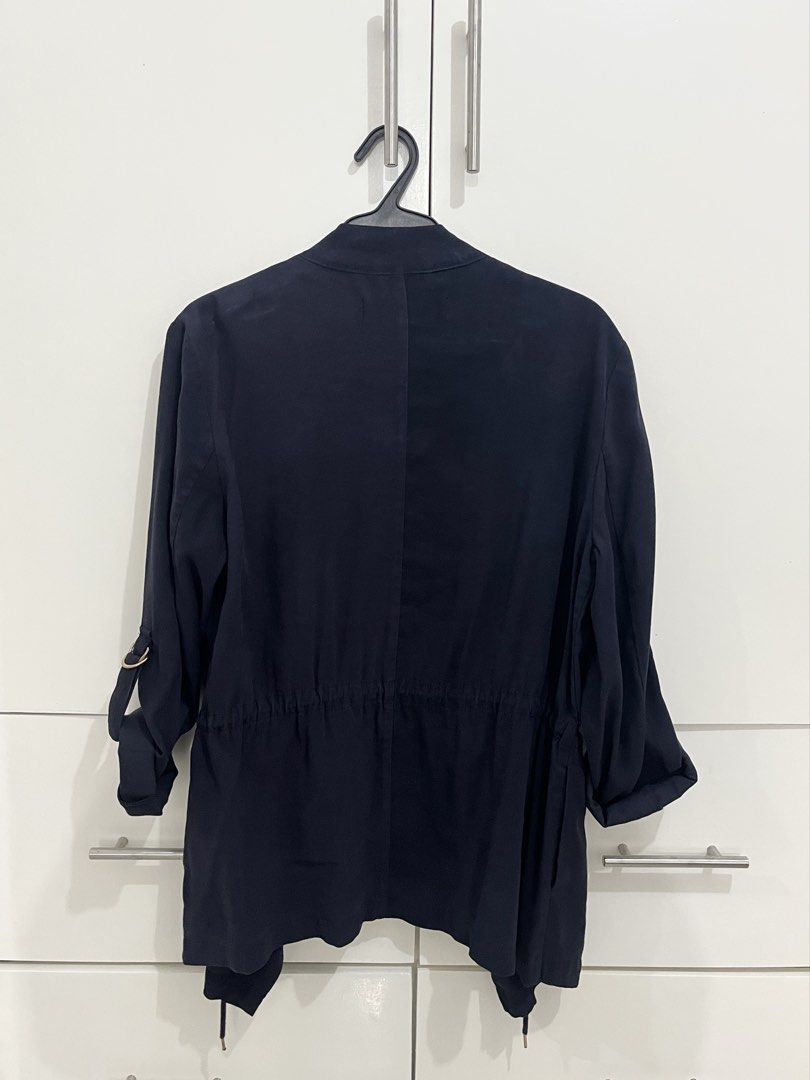 Navy Blue Shawl Blazer (Category: Coats, Jackets and Outerwear) located in Quezon City. Submitted by shoppley (Listing ID 1462954301, Image 2). Description: - Navy blue utility jacket - Drawstring waist for adjustable fit - Roll-up sleeves with tab for securing - Button closure at the front - Ideal for layering over outfits.