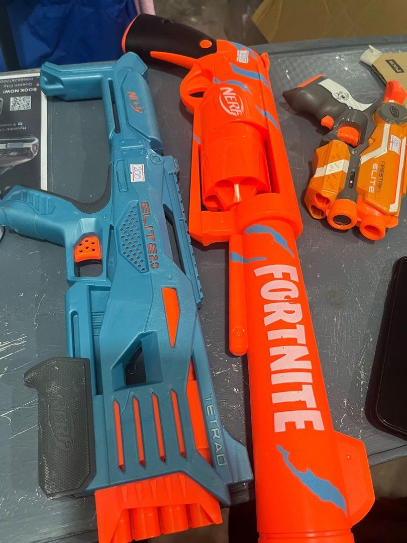 Nerf Elite Tetrad and Fortnite Blasters (Category: Action & Battle Toys) located in Quezon City. Submitted by decluttercollection01 (Listing ID 1463075895, Image 1). Description: - Two Nerf blasters available: Blue Nerf Elite Tetrad and Orange Nerf Fortnite blaster. - Both blasters are in good working condition. - Selling for P200 each. - Ideal for kids' playtime or for Nerf collectors..