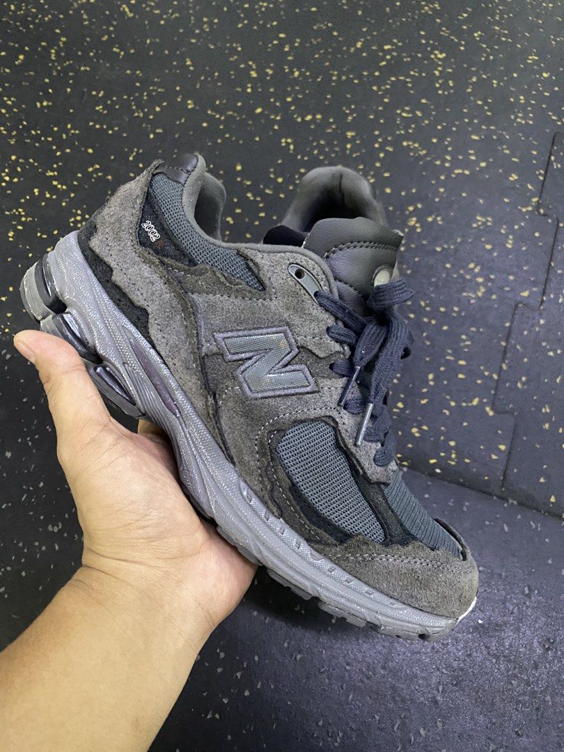 New Balance 2002R distressed-effect sneakers (Category: Sneakers) located in Quezon City. Submitted by capsanywhere (Listing ID 1462888409, Image 2). Description: - Grey New Balance 2002R sneakers - Made with suede and mesh - Features classic N logo on the side - Comfortable sole for all-day wear - Shows some signs of wear (toe box and sole), but plenty of life remaining - Perfect for casual outings and everyday style.