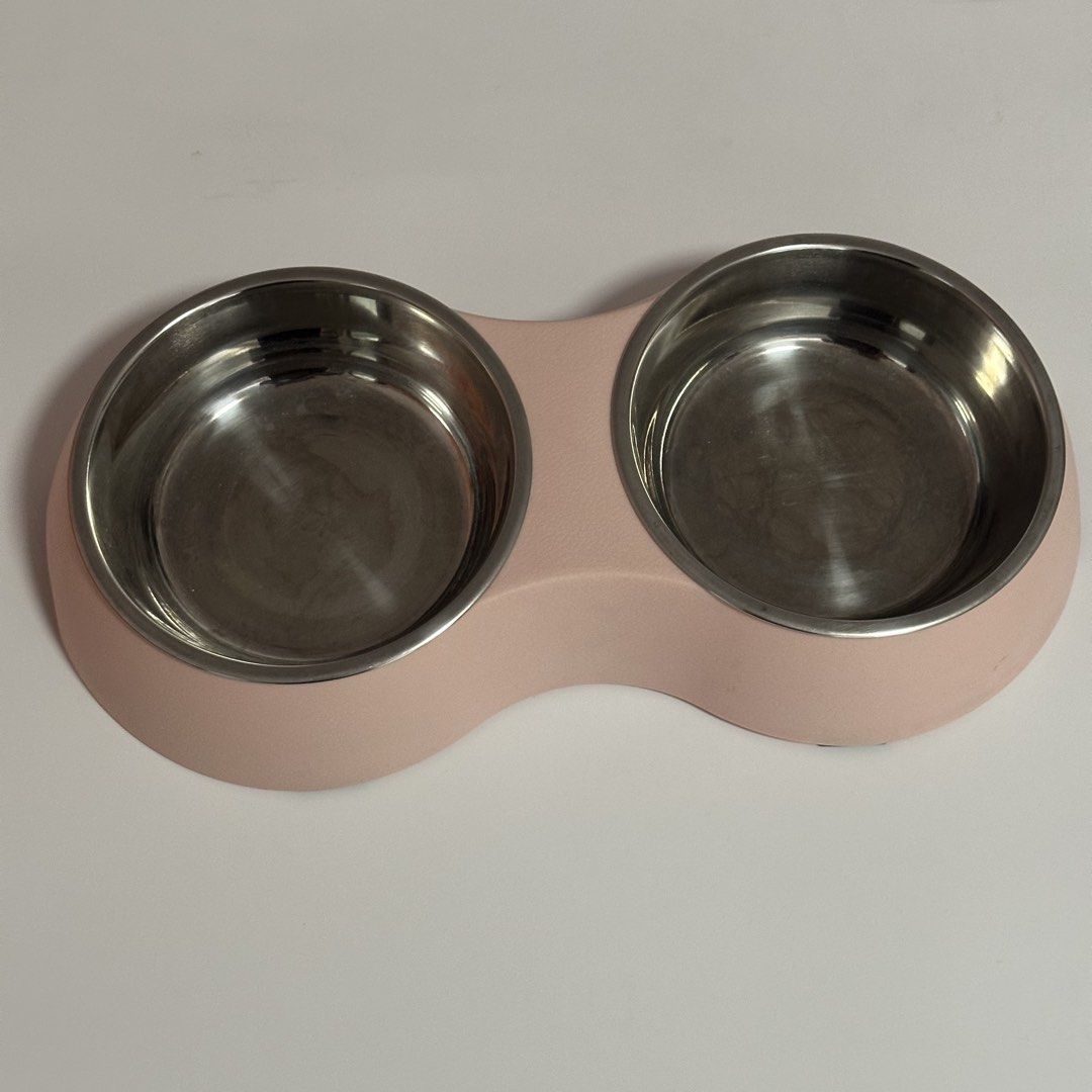 Pink Double Pet Bowl Stainless Steel Insert (Category: Homes & Other Pet Accessories) located in Quezon City. Submitted by gg.finds (Listing ID 1462952065, Image 1). Description: - Pink pet bowl with a light pink plastic base - Includes two removable stainless steel inserts - Easy to clean bowls - Ideal for serving both food and water.