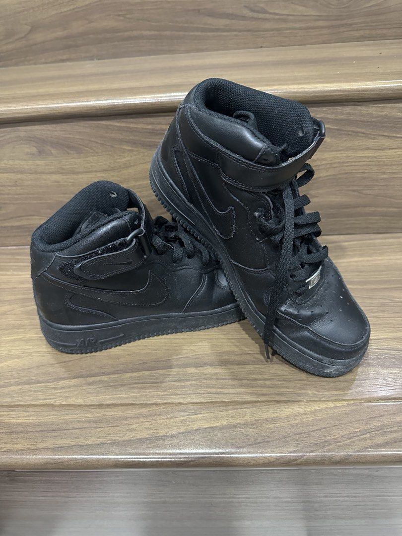 Nike Air Force 1 Mid Black Leather Sneakers (Category: Sneakers) located in Paranaque City. Submitted by mcrisdelacruz (Listing ID 1463019384, Image 1). Description: - Black Nike Air Force 1 Mid sneakers - Genuine leather material - Mid-top design with adjustable velcro strap - Iconic Air Force 1 silhouette - Minor signs of wear on soles and toe box - Perfect for everyday wear and casual style.
