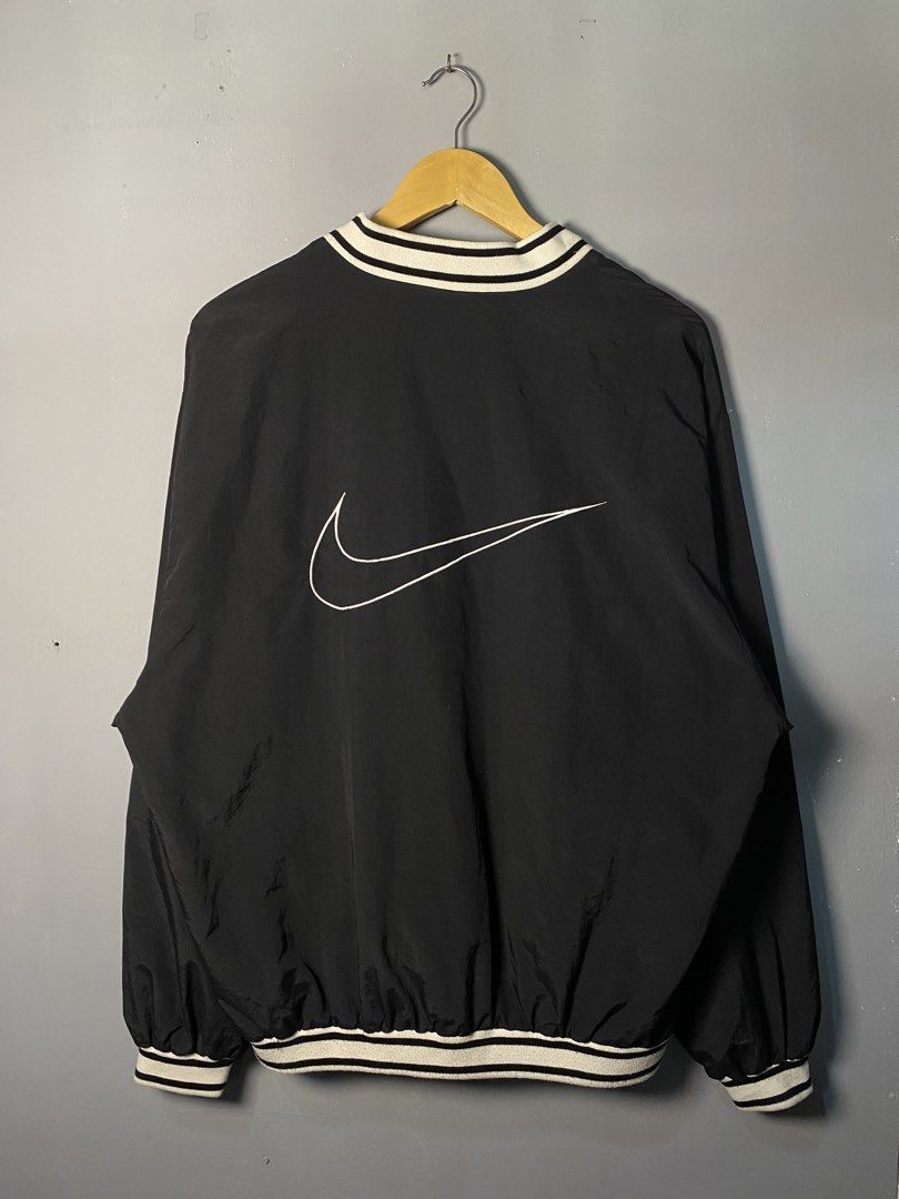 Nike Black Pullover V-Neck Jacket (Category: Coats, Jackets and Outerwear) located in Caloocan City. Submitted by adlnce (Listing ID 1463013886, Image 2). Description: - Classic black Nike pullover jacket - V-neck with white striped trim - Large white Swoosh logo on the back - Smaller embroidered Swoosh on the chest - Elasticated cuffs and hem - Ideal for layering or casual wear.