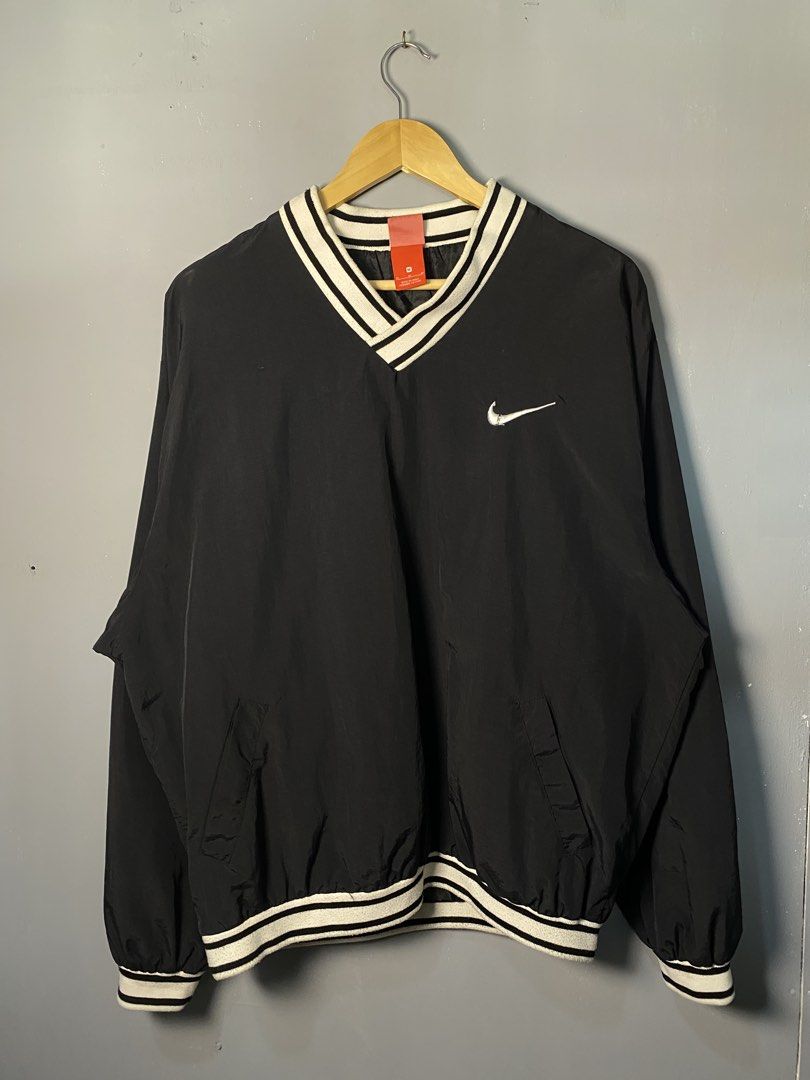 Nike Black Pullover V-Neck Jacket (Category: Coats, Jackets and Outerwear) located in Caloocan City. Submitted by adlnce (Listing ID 1463013886, Image 1). Description: - Classic black Nike pullover jacket - V-neck with white striped trim - Large white Swoosh logo on the back - Smaller embroidered Swoosh on the chest - Elasticated cuffs and hem - Ideal for layering or casual wear.