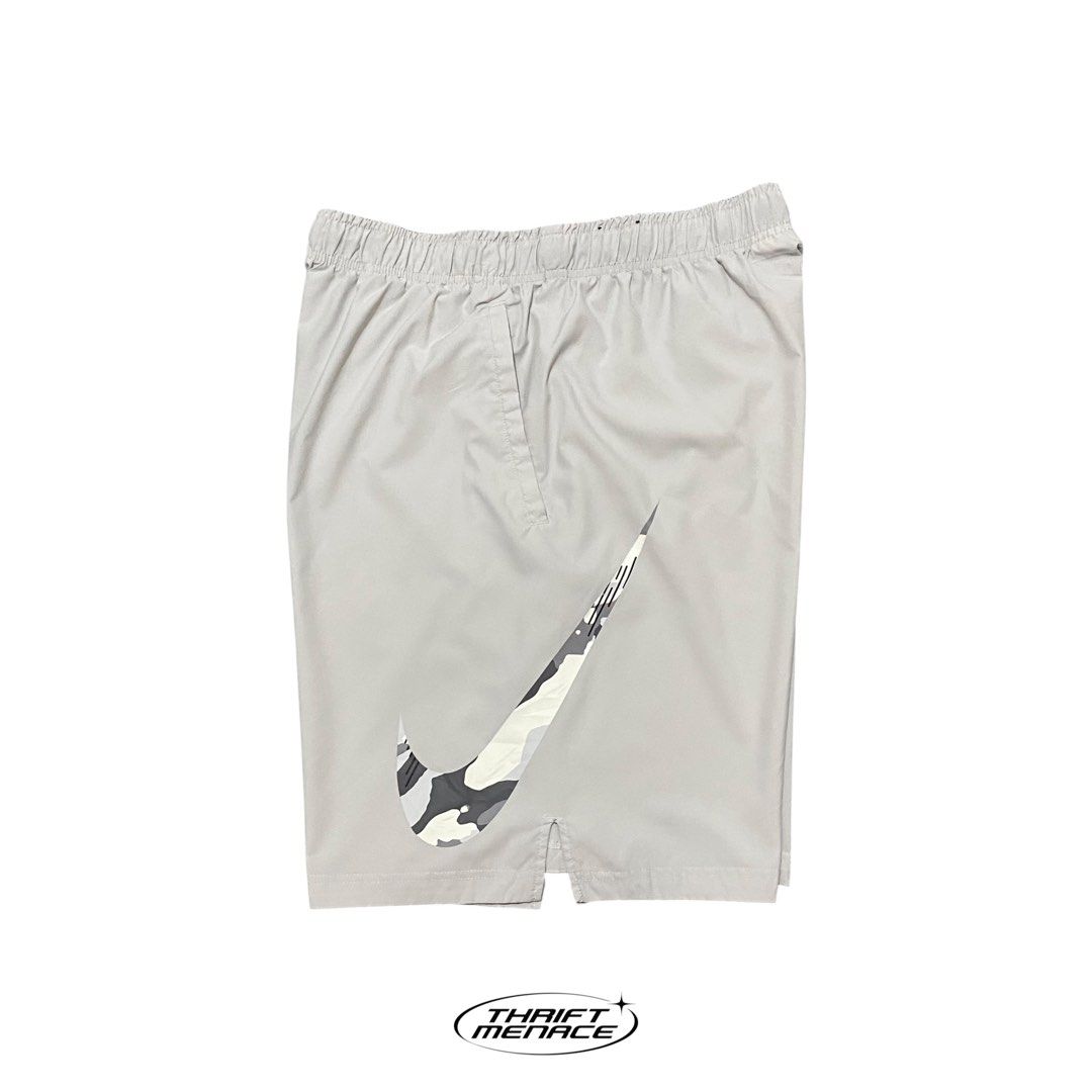 Nike Grey Camo Swoosh Athletic Shorts (Category: Shorts) located in Manila. Submitted by urboycee (Listing ID 1463091637, Image 1). Description: - Grey Nike shorts - Features a cool camo swoosh graphic - Elastic waistband with drawstring for adjustable fit - Convenient side pockets - Ideal for sports, workouts, or casual everyday wear - Comfortable and stylish design.