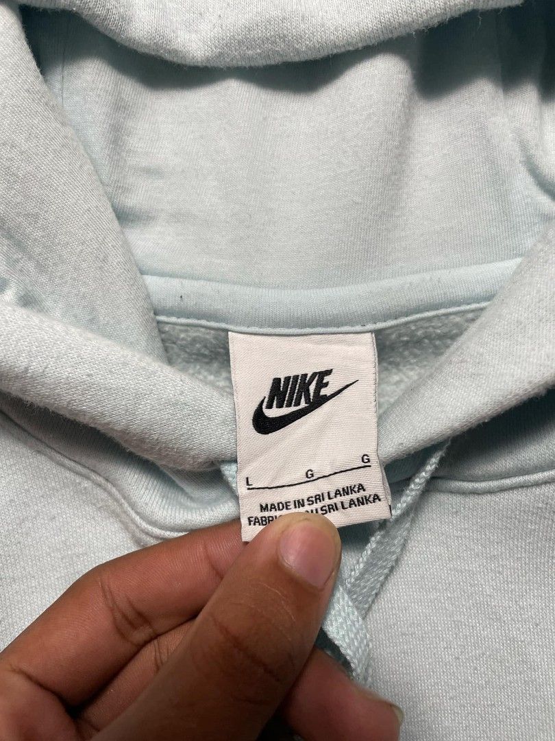 Nike Light Blue Pullover Hoodie Size L (Category: Coats, Jackets and Outerwear) located in Ligao. Submitted by merjudioma64633 (Listing ID 1463010509, Image 2). Description: - Light blue Nike hoodie - Size L - Made in Sri Lanka - Front pocket - Drawstring hood - Small embroidered Nike logo on chest - Comfortable and casual - Perfect for everyday wear.