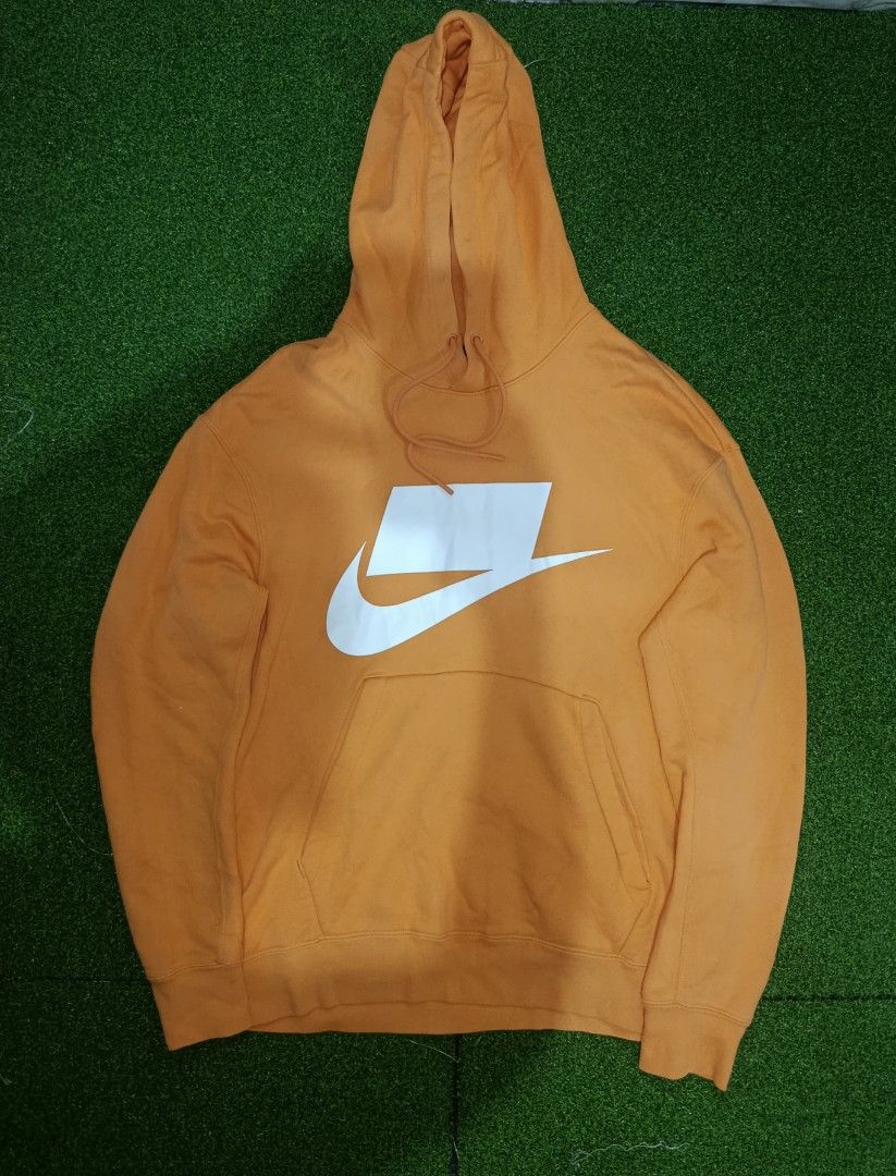 NIKE NSW NSP HOODIE JACKET (Category: Hoodies) located in Valenzuela. Submitted by d.repolthrift (Listing ID 1463010076, Image 2). Description: - Orange Nike hoodie -Size:Small -Width:22 -Length:25 -Good as new condition -Fresh from bale -Wash dirt - Large white swoosh logo on front - Front pocket for convenience - Adjustable drawstring hood - 'NOT A SAMPLE' graphic on the back - Ideal for everyday casual wear.