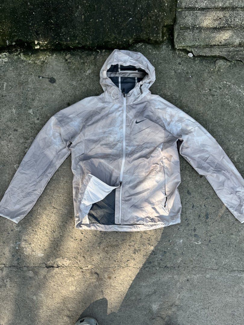 Nike Storm-FIT Running Division Jacket Grey White Men's (Category: Coats, Jackets and Outerwear) located in Caloocan City. Submitted by apis.ant (Listing ID 1463065751, Image 1). Description: - Nike Storm-FIT Running Division Jacket - Lightweight and water-repellent - Features a hood and zippered pockets - Subtle grey and white pattern - Ideal for running or everyday wear - Reason for selling: Incorrect size.