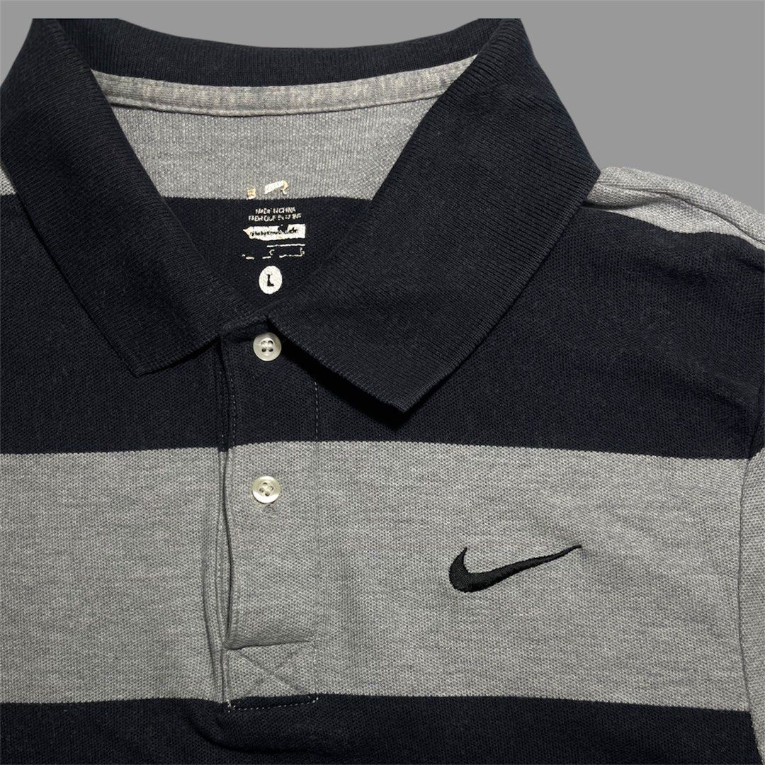 Nike Striped Polo Shirt (Category: Tshirts & Polo Shirts ) located in Cavite. Submitted by allen19deg89858 (Listing ID 1462999590, Image 2). Description: - Classic Nike polo shirt - Navy and grey stripe design - Small Nike swoosh logo on chest - Button-up collar - Size: Large (L) - Ideal for casual outings or golf.