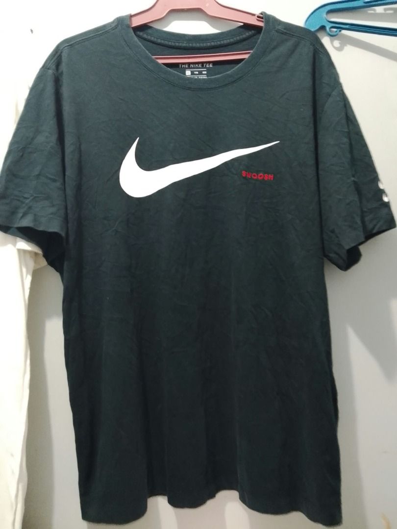 Nike Swoosh T-Shirt Black (Category: Tshirts & Polo Shirts ) located in Boljoon. Submitted by trip-to-the-thrift (Listing ID 1463075541, Image 1). Description: - Classic black Nike t-shirt - Large white swoosh logo on the front - Small red 'Swoosh' text detail - Double swoosh logo on the sleeve - Made from comfortable cotton material - Perfect for casual everyday wear 400 shipped .