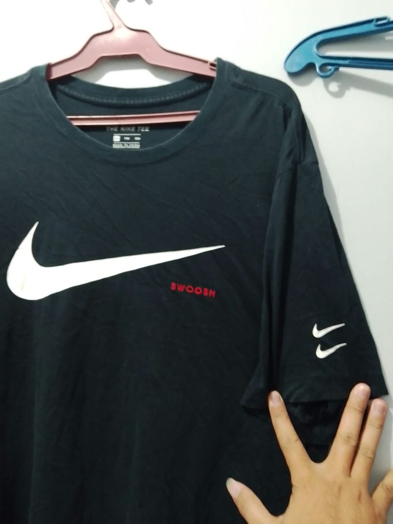 Nike Swoosh T-Shirt Black (Category: Tshirts & Polo Shirts ) located in Boljoon. Submitted by trip-to-the-thrift (Listing ID 1463075541, Image 2). Description: - Classic black Nike t-shirt - Large white swoosh logo on the front - Small red 'Swoosh' text detail - Double swoosh logo on the sleeve - Made from comfortable cotton material - Perfect for casual everyday wear 400 shipped .