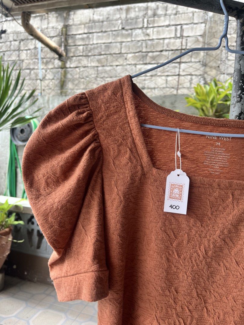 Nine West Rust Square Neck Puff Sleeve Top (Category: Blouses) located in Dinalupihan. Submitted by penaflorcj (Listing ID 1462917820, Image 2). Description: - Color: Rust (Also available in black) - Neckline: Square - Sleeves: Puff sleeves - Material: Textured fabric - Style: Versatile for casual or dressed-up looks rfs:decluttering *sale price + discount when you buy more than 2 items.