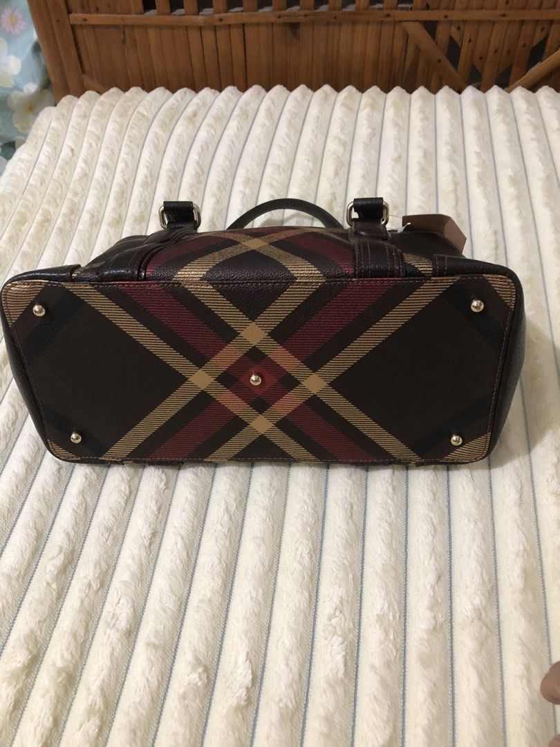 Daks Brown Plaid Leather Tote Bag (Category: Tote Bags) located in Rizal. Submitted by elviedc2420209 (Listing ID 1463035062, Image 3). Description: - Brown Daks handbag with classic plaid pattern - Genuine leather trim and handles - Elegant gold hardware details - Interior zippered pocket for essentials - Protective studs on the bottom - Ideal for everyday style and practicality.