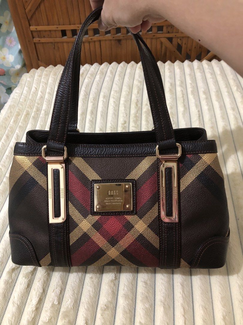 Daks Brown Plaid Leather Tote Bag (Category: Tote Bags) located in Rizal. Submitted by elviedc2420209 (Listing ID 1463035062, Image 1). Description: - Brown Daks handbag with classic plaid pattern - Genuine leather trim and handles - Elegant gold hardware details - Interior zippered pocket for essentials - Protective studs on the bottom - Ideal for everyday style and practicality.