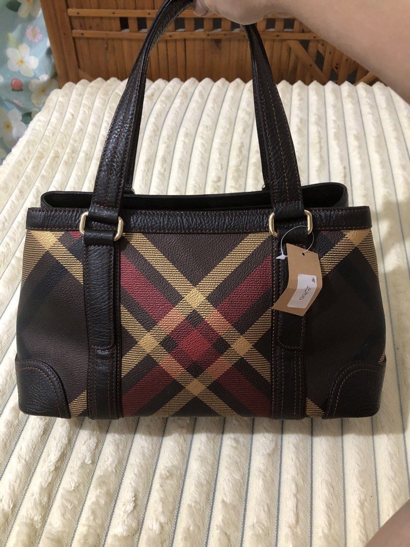 Daks Brown Plaid Leather Tote Bag (Category: Tote Bags) located in Rizal. Submitted by elviedc2420209 (Listing ID 1463035062, Image 2). Description: - Brown Daks handbag with classic plaid pattern - Genuine leather trim and handles - Elegant gold hardware details - Interior zippered pocket for essentials - Protective studs on the bottom - Ideal for everyday style and practicality.