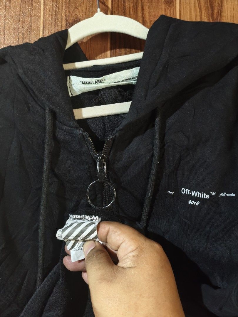 Off-White 2018 Black Zip-Up Hoodie (Category: Hoodies) located in Caloocan City. Submitted by ilapinto (Listing ID 1462964514, Image 3). Description: - Authentic Off-White Black Zip-Up Hoodie - Iconic Off-White arrows graphic on the back - Signature diagonal stripes on the sleeves - Unique ring zipper pull - Made in 2018 (refer to tags for verification).