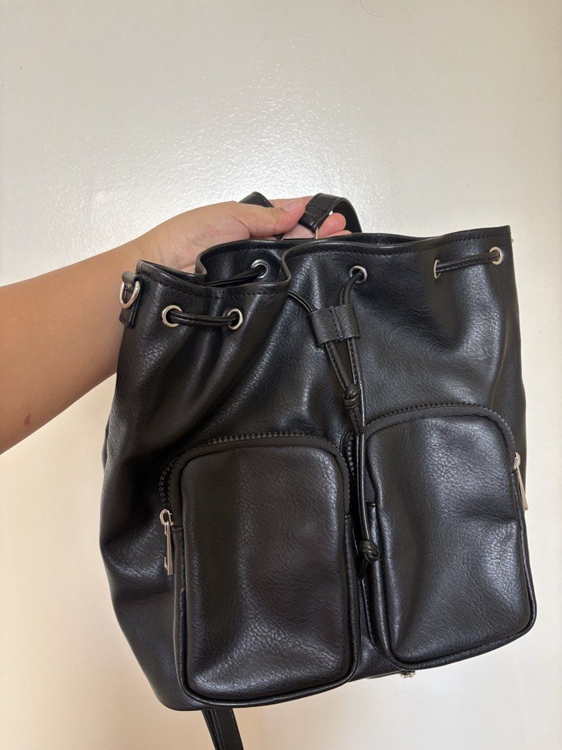 OG GU Black Leather Drawstring Backpack with Front Pockets (Category: Backpacks) located in Quezon City. Submitted by karinadv (Listing ID 1462953148, Image 1). Description: - OG GU backpack bought in HK - Two zippered pockets on the front for easy access - Secure drawstring closure at the top - Interior features a couple of small pockets for organization - Shoulder strap not included (missing).