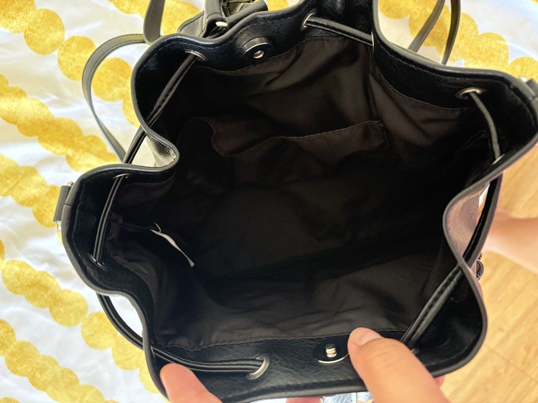 OG GU Black Leather Drawstring Backpack with Front Pockets (Category: Backpacks) located in Quezon City. Submitted by karinadv (Listing ID 1462953148, Image 3). Description: - OG GU backpack bought in HK - Two zippered pockets on the front for easy access - Secure drawstring closure at the top - Interior features a couple of small pockets for organization - Shoulder strap not included (missing).