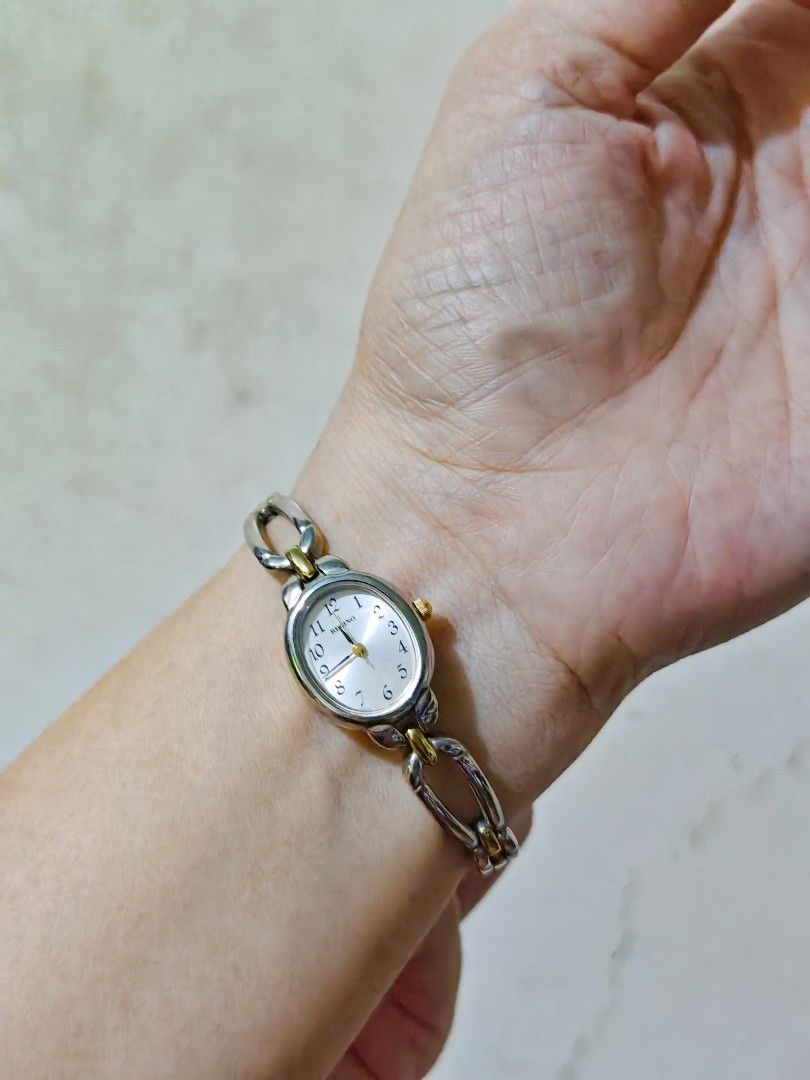Orig Reguno Two-Tone Ladies Watch (Category: Women's Watches) located in Taguig. Submitted by mystuff4youph (Listing ID 1463063621, Image 1). Description: - Reguno dainty watch - Silver and gold tone metal bracelet - Oval face with light brown(peach) dial - Clearly marked numbers 1-12 - Water resistant - Base metal bezel - Classic accessory for everyday wear - bought in Japan - No issue - Perfectly working! .