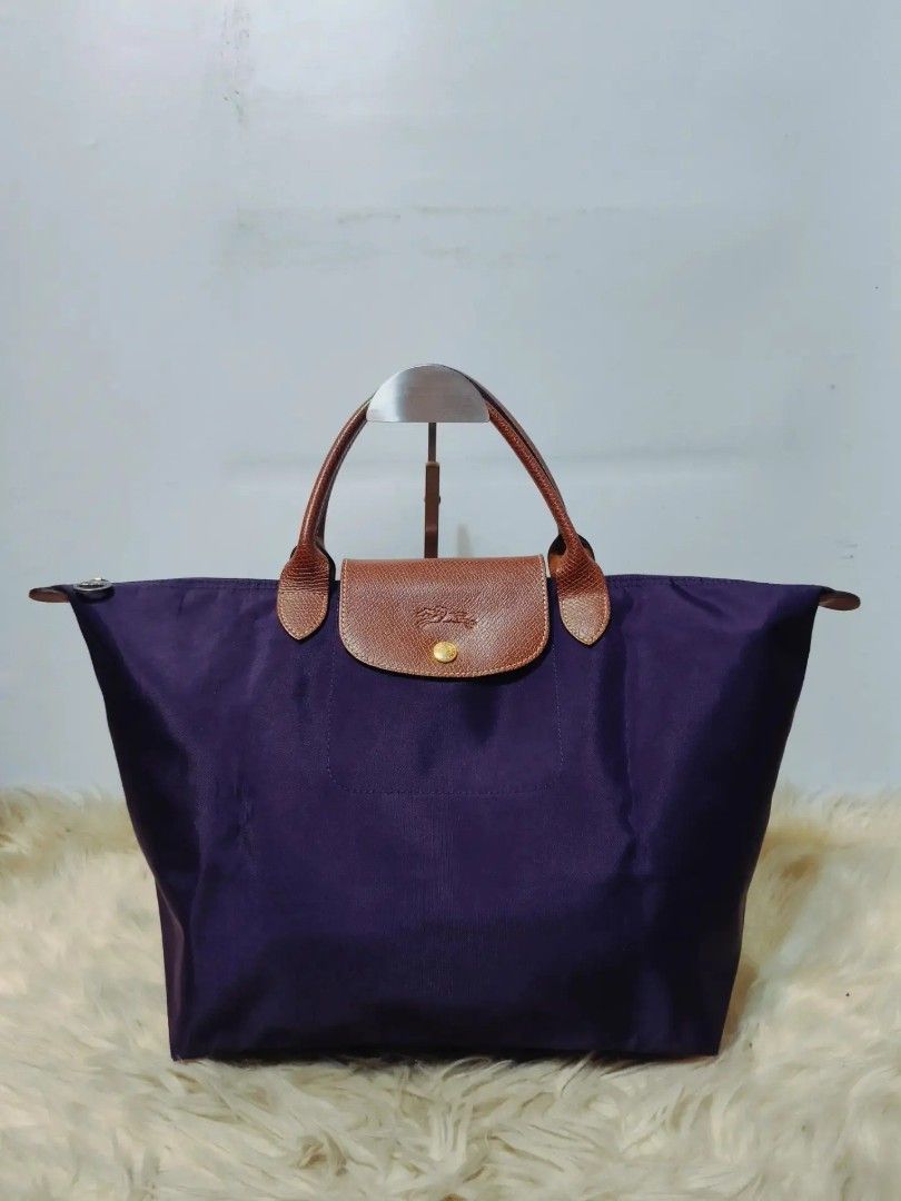 Original Longchamp Le Pliage Tote Bag (Category: Shoulder Bags) located in Cabuyao City. Submitted by secondhand.shop.ph (Listing ID 1462940718, Image 1). Description: Sale❗Sale❗Sale❗ ₱2,680 Original LONGCHAMP Medium Short handle(MSH) Almost new Purple nylon & genuine leather 📌First to pay.