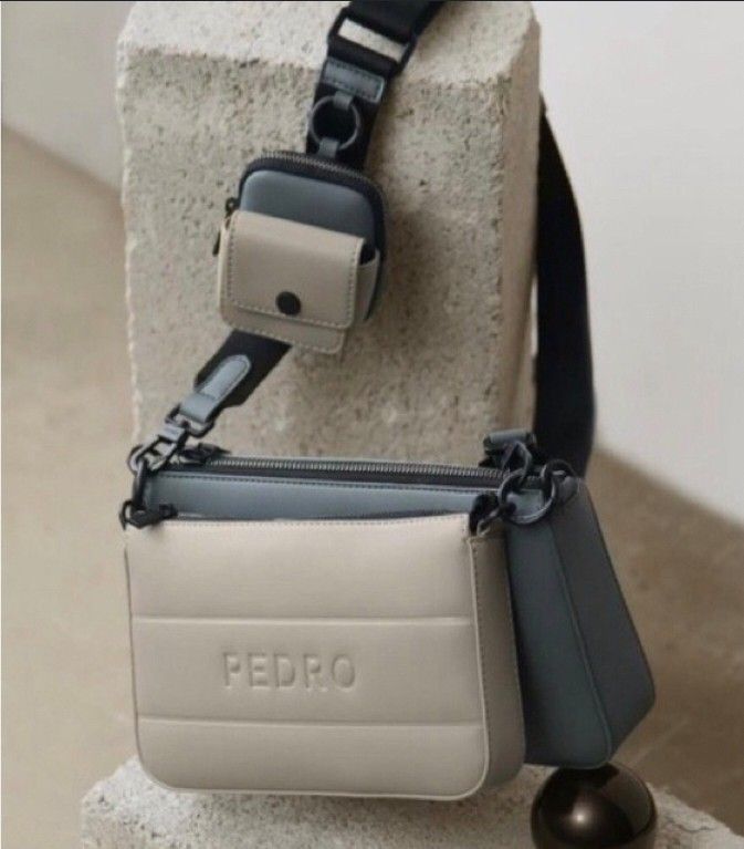 ORIGINAL PEDRO 2PC SLING BAG (Category: Cross-body Bags) located in Caloocan City. Submitted by mluck (Listing ID 1462977998, Image 2). Description: multi-tone grey and cream Pedro Frank Sling Bag featuring a detachable mini earphone holder pouch and embossed front branding..