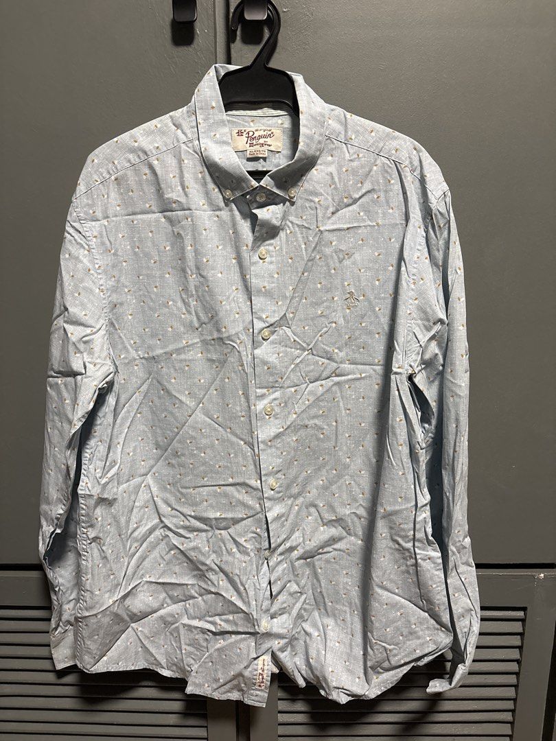Original Penguin Men's Button-Up Shirt (Category: Tshirts & Polo Shirts ) located in Manila. Submitted by allenv.2k (Listing ID 1463062101, Image 1). Description: - Brand: Original Penguin - Color: Light Blue - Style: Button-up shirt - Features: Subtle all-over pattern, button-down collar, long sleeves - Occasion: Casual wear.