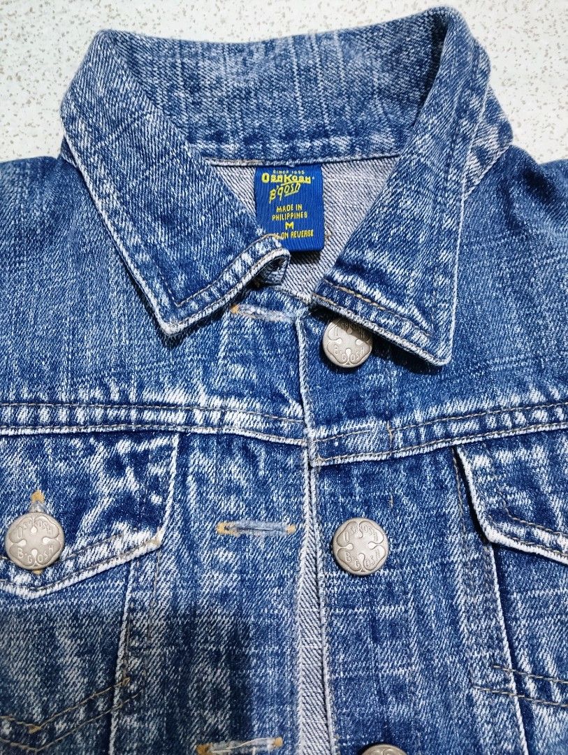 OshKosh B'gosh Kids Denim Jacket Size M (Category: Babies & Kids Fashion) located in General Santos City (Dadiangas). Submitted by rjb21 (Listing ID 1463020388, Image 2). Description: - Classic blue denim jacket for kids - Button-up front - Features chest pockets - Proudly made in the Philippines - Ideal for layering - Versatile and easy to style with any outfit - A wardrobe essential for children best fit 2-4 years old.