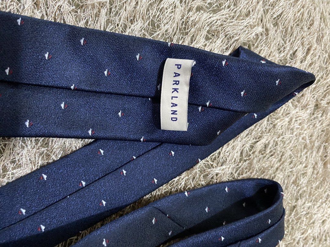 Parkland Navy Blue Silk Tie with Small Pattern (Category: Ties) located in Bulacan. Submitted by rich2545 (Listing ID 1462905115, Image 2). Description: - Brand: Parkland - Color: Navy Blue - Material: Silk - Design: Subtle pattern of small red and white shapes - Occasion: Formal or Business Wear.