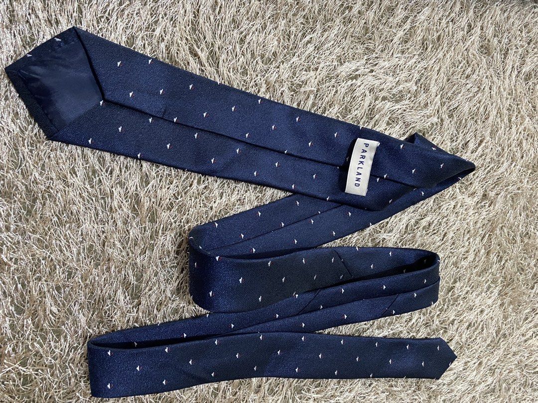 Parkland Navy Blue Silk Tie with Small Pattern (Category: Ties) located in Bulacan. Submitted by rich2545 (Listing ID 1462905115, Image 3). Description: - Brand: Parkland - Color: Navy Blue - Material: Silk - Design: Subtle pattern of small red and white shapes - Occasion: Formal or Business Wear.