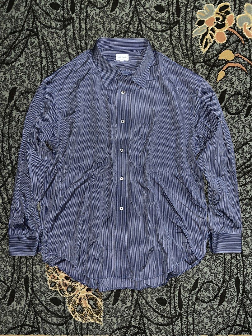 Paul Smith B/W Stripped (Category: Formal Shirts) located in Manila. Submitted by kashjulliane (Listing ID 1462968824, Image 1). Description: This is a classic blue and white striped dress shirt from the renowned British designer label Paul Smith London. It features a traditional pointed collar, alternating fine blue and white vertical stripes, and a central button placket with a dark pearlescent button. Excellent condition Good as new Made in Ja