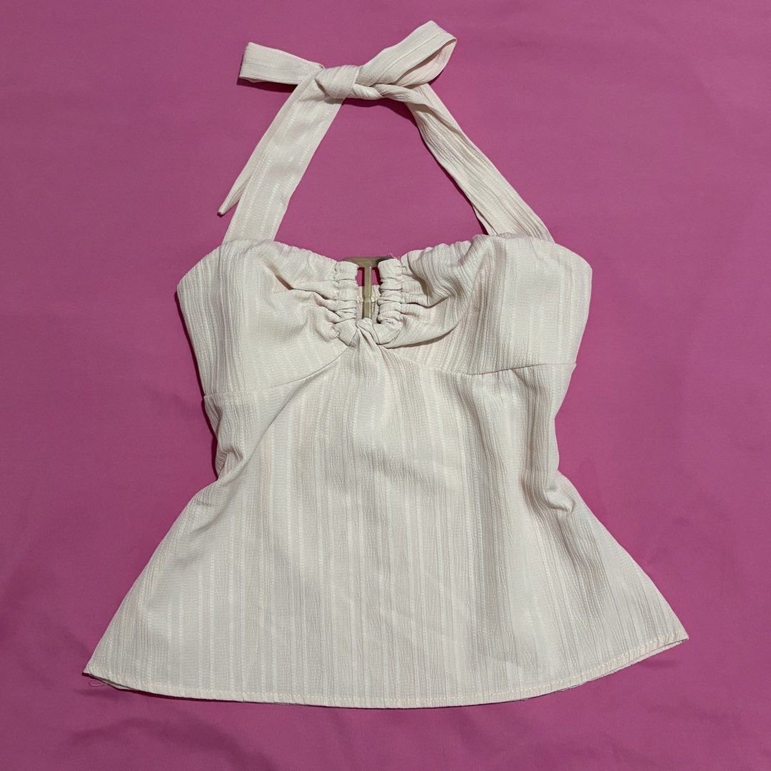 Pink Textured Halter Neck Top with Tie Back (Category: Sleeveless) located in Quezon City. Submitted by luna_ily (Listing ID 1463096008, Image 1). Description: 🍒 With a non-slip silicone gripper and zipper by the side. 🍒 In good condition except from few loose threads. 🍒 Send a message for more pictures (such as when worn) and inquiries. Location: Cubao, Quezon City Mode of delivery: J&T and Lalamove (shipping fee will be shouldered by the buy