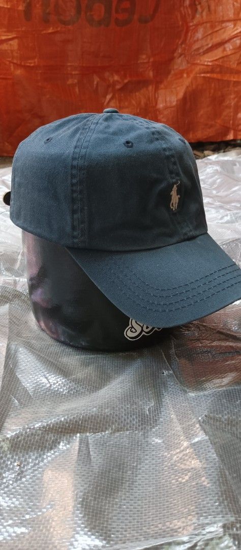 Polo Ralph Lauren Baseball Cap Navy Blue (Category: Caps & Hats) located in Quezon City. Submitted by mangthrift (Listing ID 1463038218, Image 3). Description: - Classic navy blue Polo Ralph Lauren baseball cap - Iconic polo player logo embroidered on the front - 'POLO' embroidered on the back - Adjustable leather strap for a comfortable fit Adult Size - Perfect for everyday wear - Need wash only.