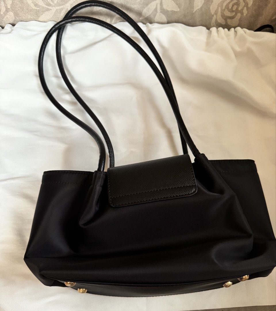 Pony Pony Black Nylon Shoulder Bag (Category: Shoulder Bags) located in San Fernando. Submitted by shopsarang17714 (Listing ID 1462938678, Image 2). Description: - Used once - Bought through BKK Pasabuy - Stylish black nylon shoulder bag - Ample interior space for essentials - Ideal for everyday wear - Comes with a protective dust bag.