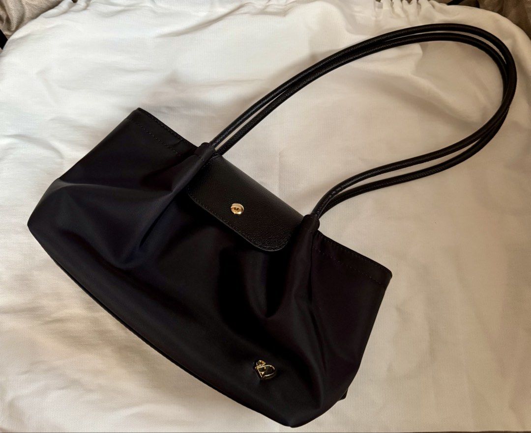 Pony Pony Black Nylon Shoulder Bag (Category: Shoulder Bags) located in San Fernando. Submitted by shopsarang17714 (Listing ID 1462938678, Image 1). Description: - Used once - Bought through BKK Pasabuy - Stylish black nylon shoulder bag - Ample interior space for essentials - Ideal for everyday wear - Comes with a protective dust bag.
