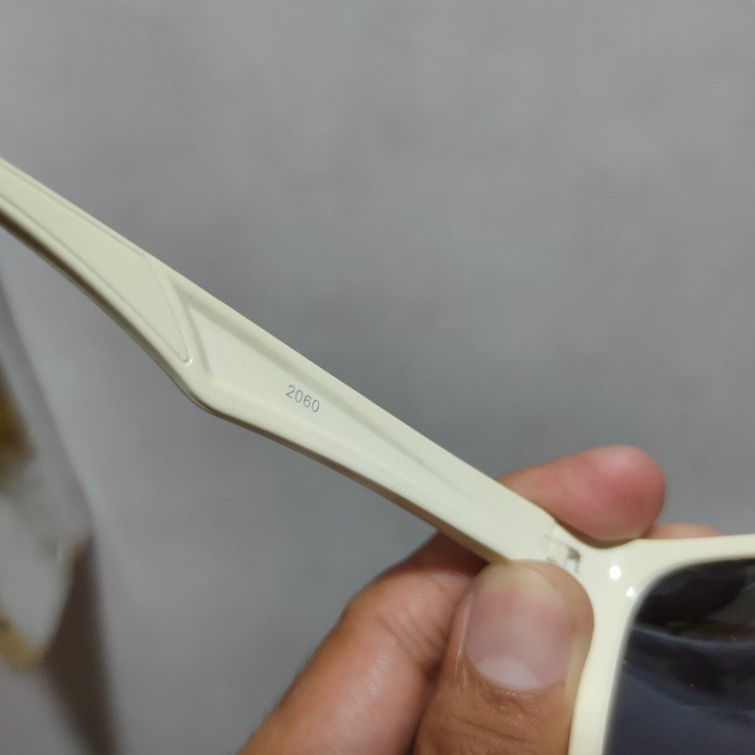 Prada 2060 Sunglasses Cream/White (Category: Sunglasses & Eyewear) located in Taguig. Submitted by actualizeboutique (Listing ID 1463028216, Image 3). Description: - Authentic Prada Sunglasses - Model: 2060 - Color: Cream - Lenses: Blue - Made in Italy - Features Prada logo on the side - Ideal for sunny weather - Selling on behalf of a friend.