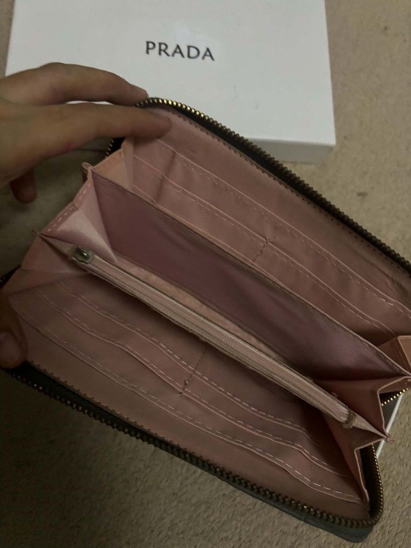 Prada Quilted Zip Around Wallet (Category: Luxury Bags & Wallets) located in Carmona. Submitted by myraprrzz (Listing ID 1462994434, Image 2). Description: - Authentic Prada wallet - Grey quilted leather with gold Prada logo - Comes with original box and packaging - Zip around closure - Multiple card slots and compartments - Ideal for everyday use.