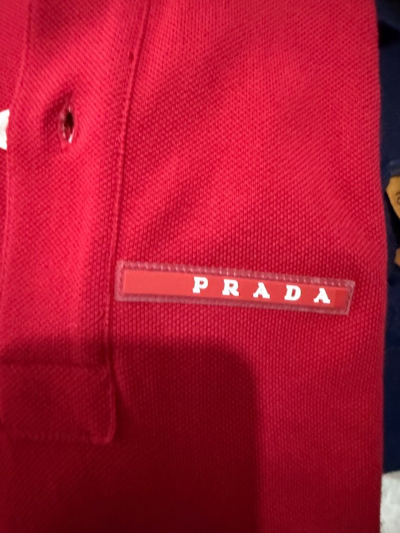 Prada Red Polo Shirt Size S (Category: Tshirts & Polo Shirts ) located in Quezon City. Submitted by ilabluxe (Listing ID 1460538665, Image 3). Description: - Authentic Prada Polo Shirt - Vibrant Bright Red Color - Classic Prada Logo Tag on Chest - Striped Detail on Collar - Short Sleeves with Striped Cuffs - Size: S - Ideal for Casual Wear 100% Authentic or Money Back Guarantee.
