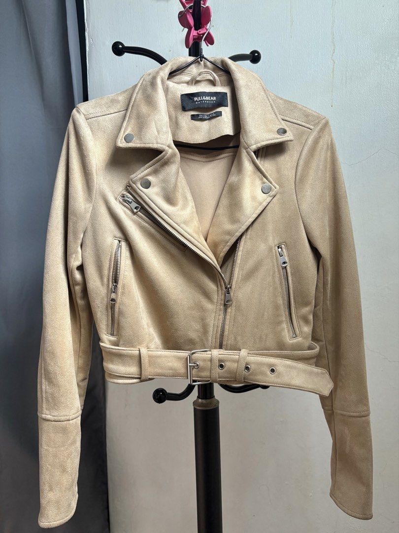 Pull & Bear Beige Suede Biker Jacket (Category: Coats, Jackets and Outerwear) located in Manila. Submitted by _noname.shop (Listing ID 1462953526, Image 2). Description: - Beige suede biker jacket - Brand: Pull & Bear - Style: Cropped with a belt at the waist - Features: Zippers on pockets and sleeves - Estimated Size: S or M - Versatile: Great for layering and pairs with everything.