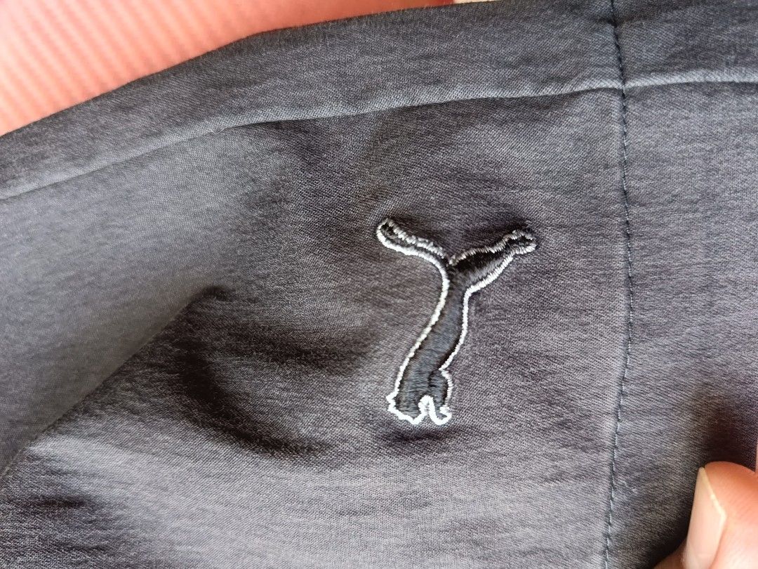 Puma Men's Casual Shorts (Category: Shorts) located in Urdaneta. Submitted by tetsudoubletaps (Listing ID 1462918966, Image 3). Description: 30 - 32 + SF - Brand: Puma - Color: Dark Grey - Material: 97% Nylon, 3% Elastane - Features: Embroidered Puma logo on left leg, 2 front pockets, 2 back pockets - Closure: Button and zip - Ideal for: Everyday wear, light sports.