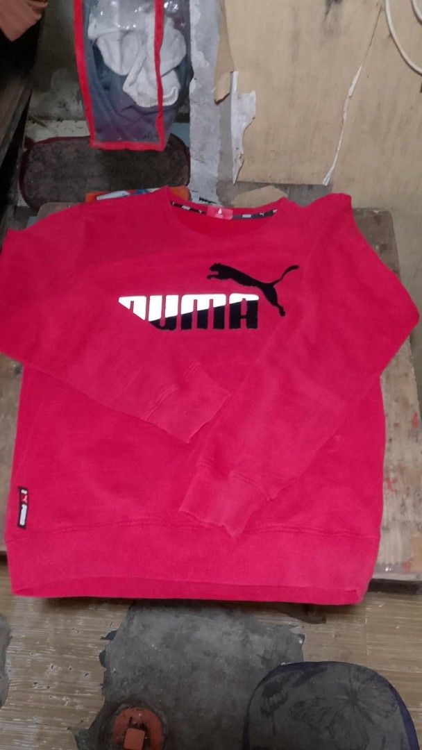Puma Red Sweatshirt with Logo (Category: Coats, Jackets and Outerwear) located in Taguig. Submitted by azshopnired (Listing ID 1463055398, Image 1). Description: - Vibrant bright red Puma sweatshirt - Features iconic Puma logo on the chest - Long sleeves with ribbed cuffs for a snug fit - Ribbed hem for a classic sweatshirt look - Ideal for everyday casual wear - Combines comfort and style effortlessly.