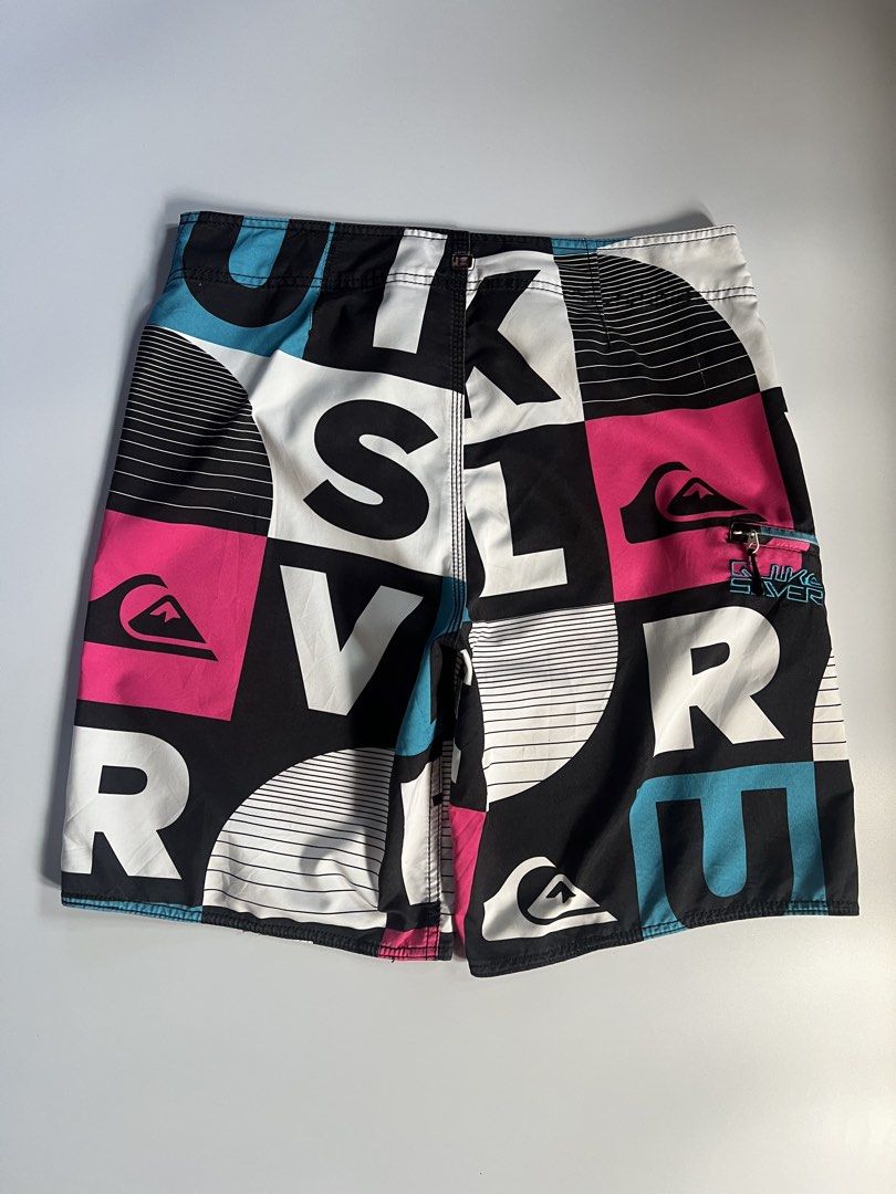 Quiksilver Board Shorts - Bold Geometric Print (Category: Swim Trunks & Board Shorts) located in Baler. Submitted by allthrifted31 (Listing ID 1462962684, Image 2). Description: - Quiksilver board shorts - Cool geometric pattern - Drawstring waist - Zippered back pocket - Quiksilver logo on leg and back pocket - Available colors: black, white, pink, teal - Ideal for swimming or lounging.