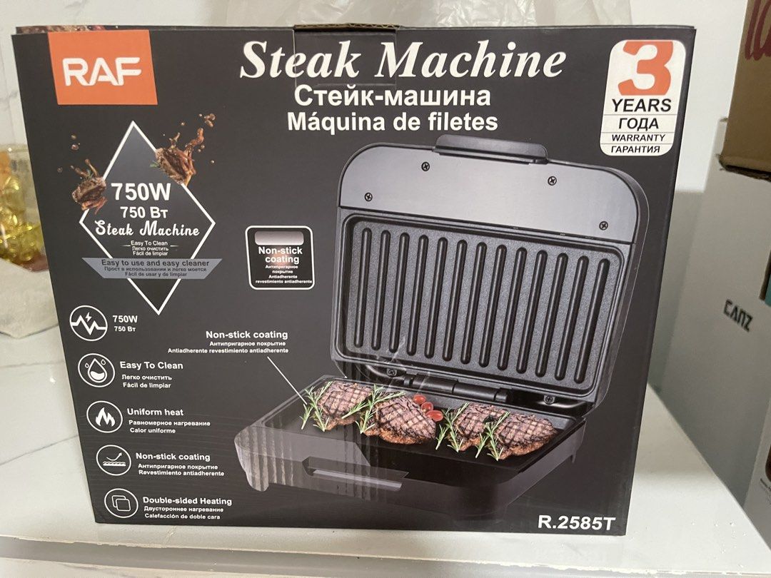 RAF Steak Machine R.2585T - 750W Grill (Category: BBQ, Grills & Hotpots) located in Malabon City. Submitted by charlize.ph (Listing ID 1462905709, Image 1). Description: - RAF Steak Machine, Model R.2585T - Powerful 750W for quick and even cooking - Non-stick coating for effortless cleaning - Double-sided heating for perfect results every time - Floating hinge system automatically adjusts to food thickness - Built-in safety lock for secure operat