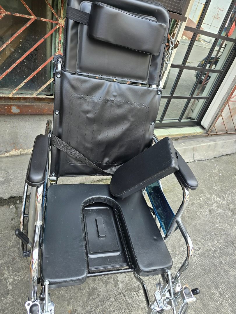 Reclining Wheelchair with commode (Category: Wheelchairs) located in Makati City. Submitted by braveturtle-4023c2 (Listing ID 1462976180, Image 2). Description: - Comfortable and supportive seating - Reclining backrest for adjustable positioning - Large rear wheels for easier maneuverability - Padded armrests for added comfort - Safety belt for enhanced security - Perfect for individuals needing mobility assistance.